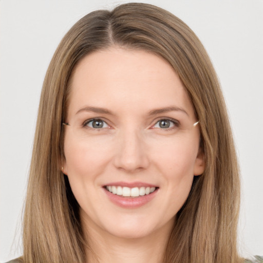 Joyful white young-adult female with long  brown hair and grey eyes