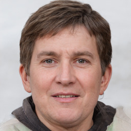 Joyful white adult male with short  brown hair and grey eyes