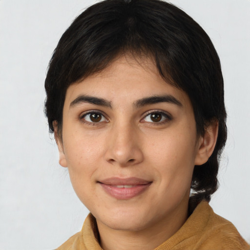Joyful latino young-adult female with medium  brown hair and brown eyes