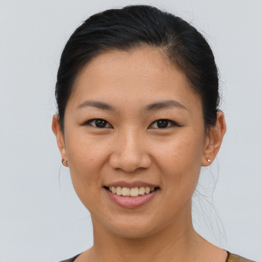 Joyful asian young-adult female with short  brown hair and brown eyes