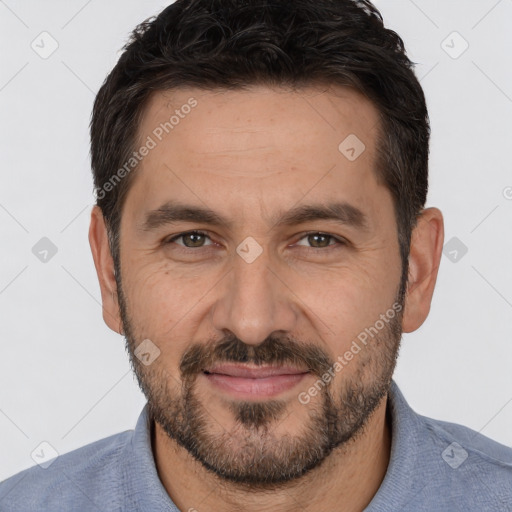 Joyful white adult male with short  brown hair and brown eyes