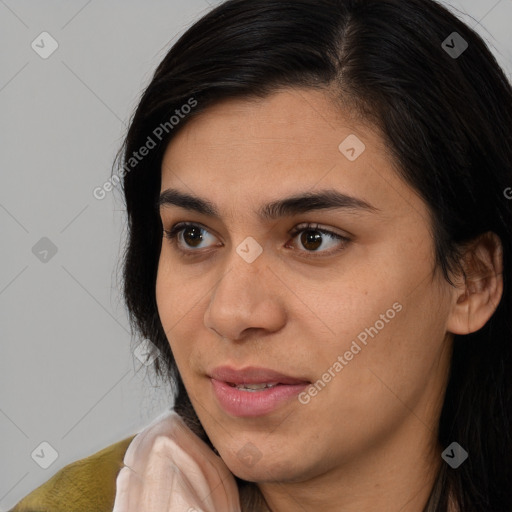 Joyful latino young-adult female with long  brown hair and brown eyes