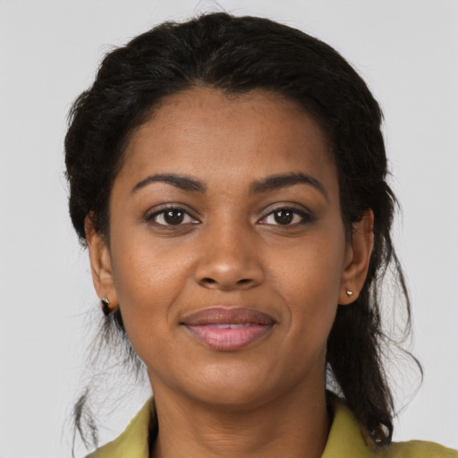 Joyful black young-adult female with medium  black hair and brown eyes