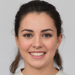 Joyful white young-adult female with medium  brown hair and brown eyes