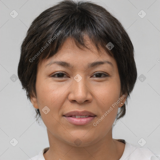 Joyful asian adult female with short  brown hair and brown eyes