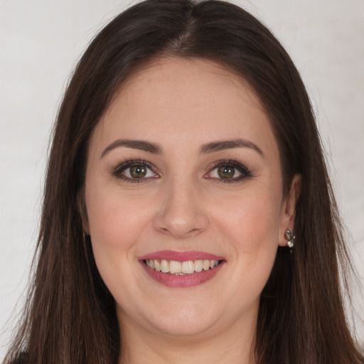 Joyful white young-adult female with long  brown hair and brown eyes