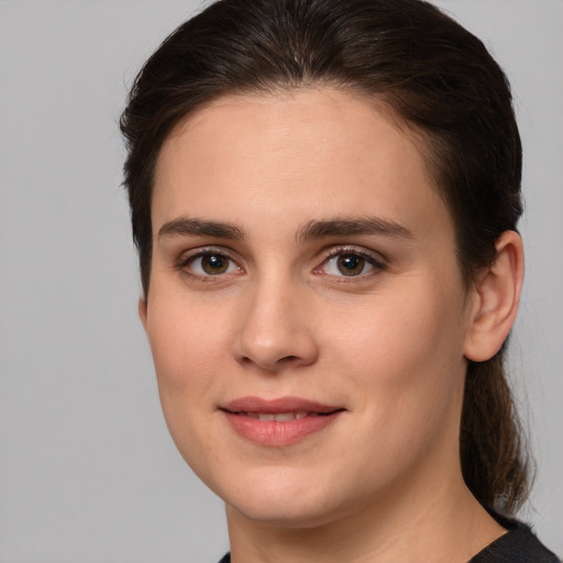 Joyful white young-adult female with medium  brown hair and brown eyes