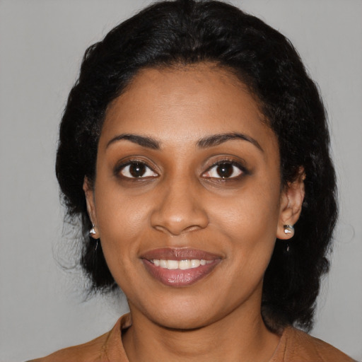 Joyful black young-adult female with medium  black hair and brown eyes