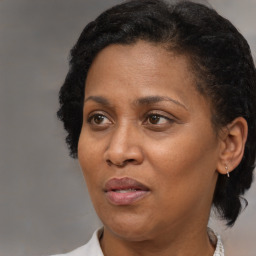 Joyful black adult female with short  brown hair and brown eyes