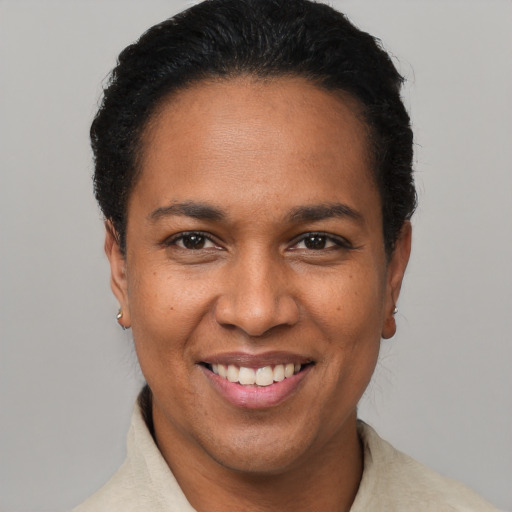 Joyful latino adult female with short  black hair and brown eyes