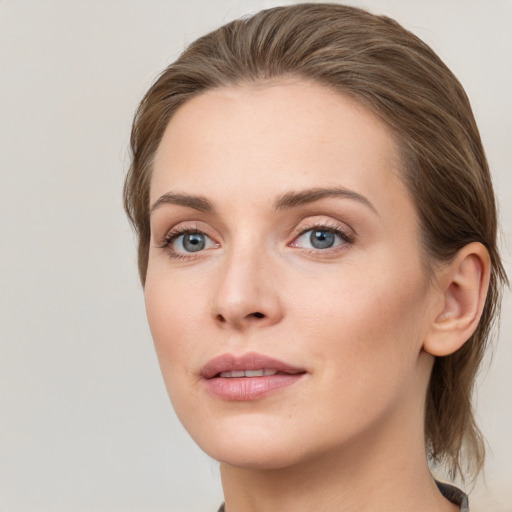 Joyful white young-adult female with medium  brown hair and blue eyes