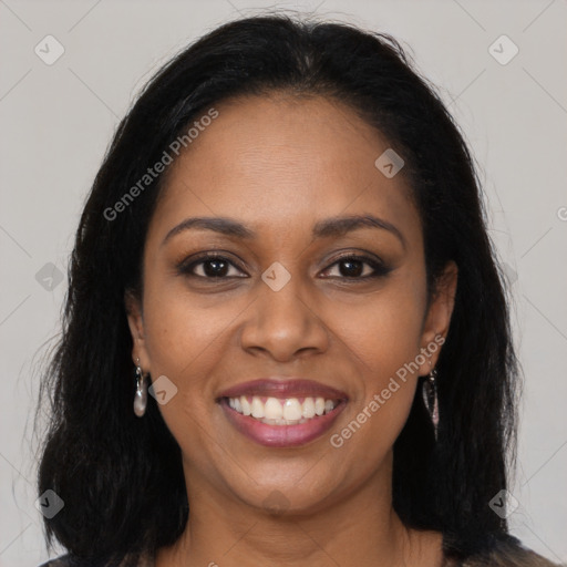 Joyful black young-adult female with long  brown hair and brown eyes