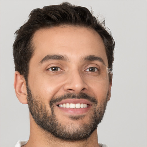 Joyful white young-adult male with short  brown hair and brown eyes