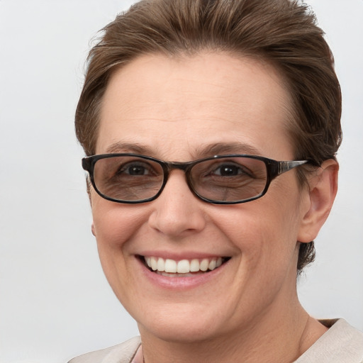 Joyful white adult female with short  brown hair and grey eyes