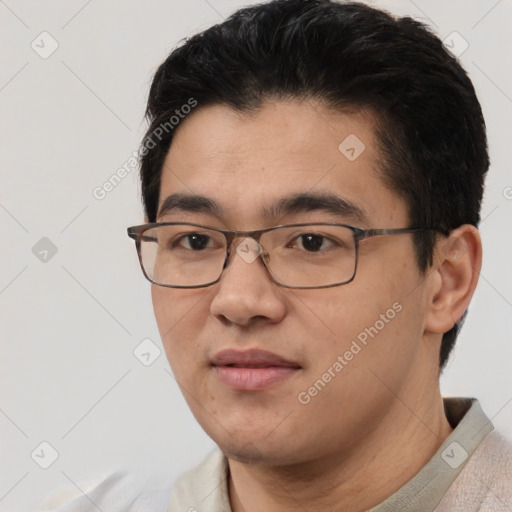 Joyful asian young-adult male with short  black hair and brown eyes