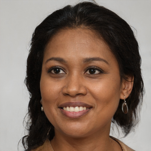 Joyful black young-adult female with long  brown hair and brown eyes