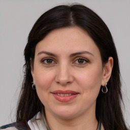 Joyful white adult female with medium  brown hair and grey eyes