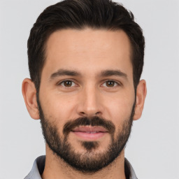 Joyful white young-adult male with short  brown hair and brown eyes