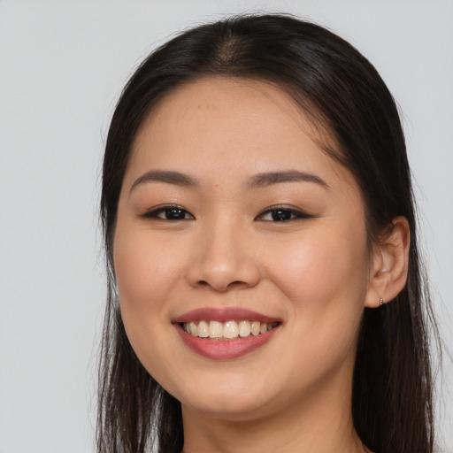 Joyful asian young-adult female with long  brown hair and brown eyes