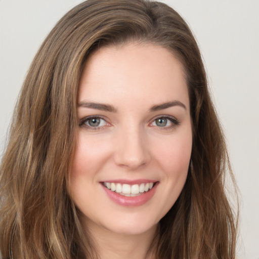 Joyful white young-adult female with long  brown hair and green eyes