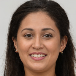 Joyful white adult female with long  brown hair and brown eyes