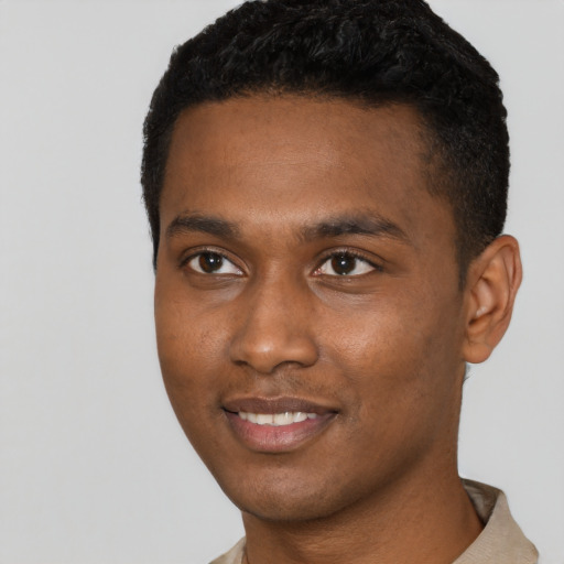Joyful black young-adult male with short  black hair and brown eyes