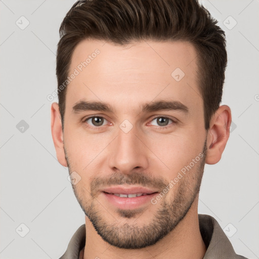 Joyful white young-adult male with short  brown hair and brown eyes