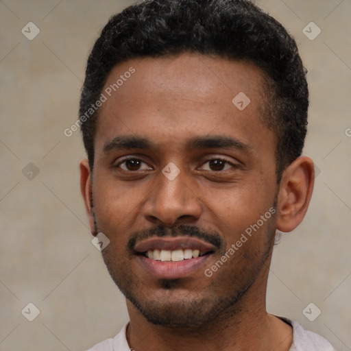 Joyful black young-adult male with short  black hair and brown eyes