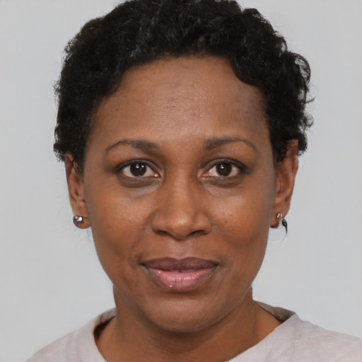 Joyful black adult female with short  brown hair and brown eyes