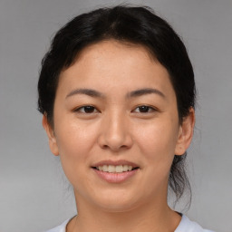 Joyful asian young-adult female with short  brown hair and brown eyes