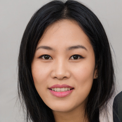 Joyful asian young-adult female with long  black hair and brown eyes