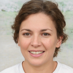 Joyful white young-adult female with medium  brown hair and green eyes