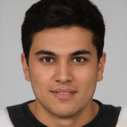 Joyful latino young-adult male with short  brown hair and brown eyes