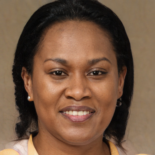 Joyful black adult female with medium  brown hair and brown eyes