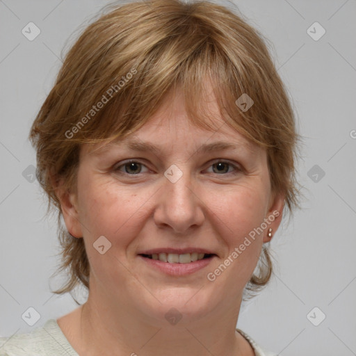 Joyful white adult female with medium  brown hair and blue eyes