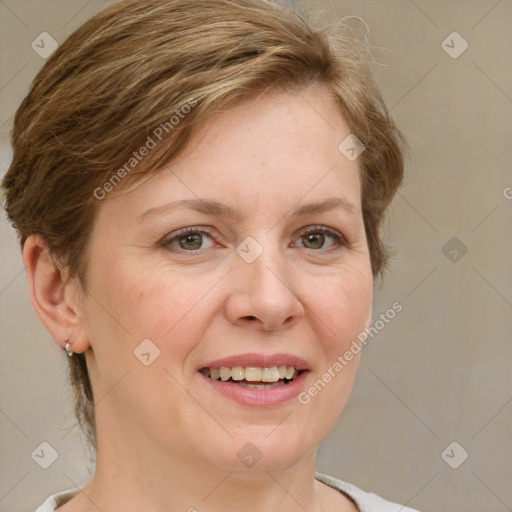 Joyful white adult female with medium  brown hair and green eyes