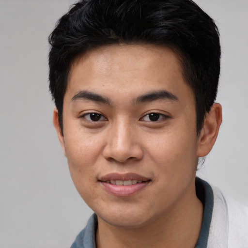 Joyful asian young-adult male with short  black hair and brown eyes