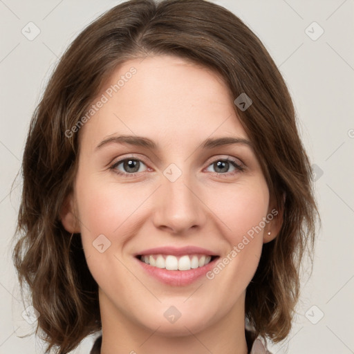 Joyful white young-adult female with medium  brown hair and green eyes