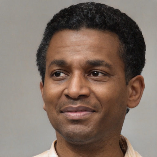 Joyful latino adult male with short  black hair and brown eyes