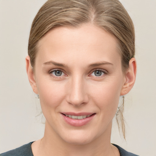 Joyful white young-adult female with medium  brown hair and blue eyes