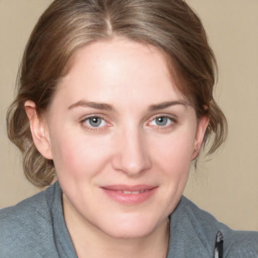 Joyful white young-adult female with medium  brown hair and blue eyes