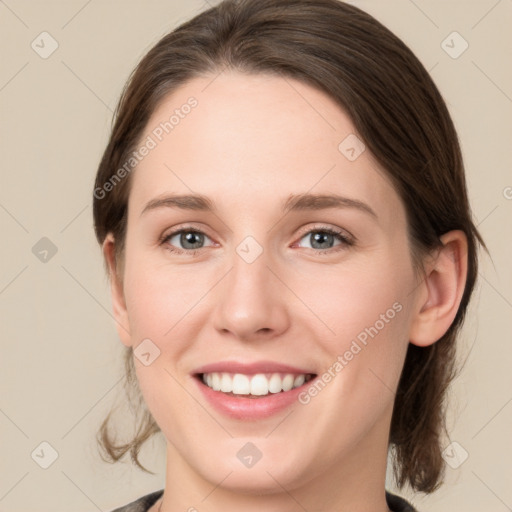 Joyful white young-adult female with medium  brown hair and green eyes