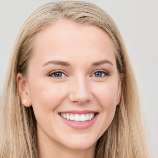 Joyful white young-adult female with long  brown hair and blue eyes