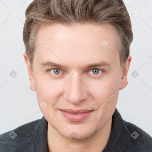 Joyful white young-adult male with short  brown hair and grey eyes