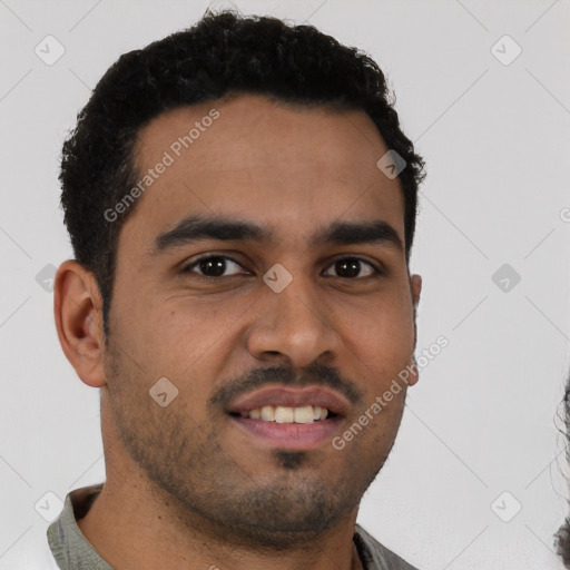 Joyful latino young-adult male with short  brown hair and brown eyes