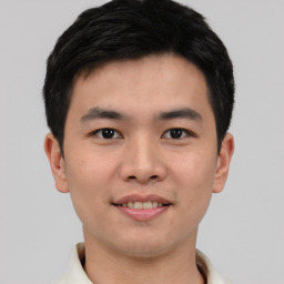 Joyful asian young-adult male with short  black hair and brown eyes