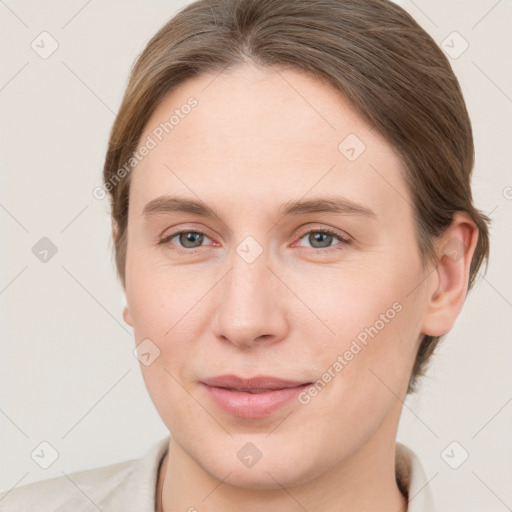 Joyful white young-adult female with short  brown hair and grey eyes