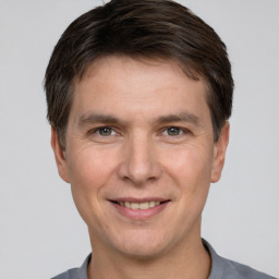 Joyful white adult male with short  brown hair and brown eyes