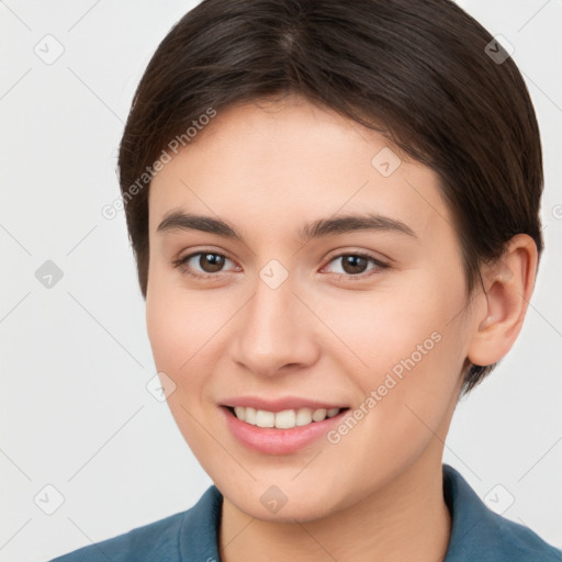 Joyful white young-adult female with short  brown hair and brown eyes