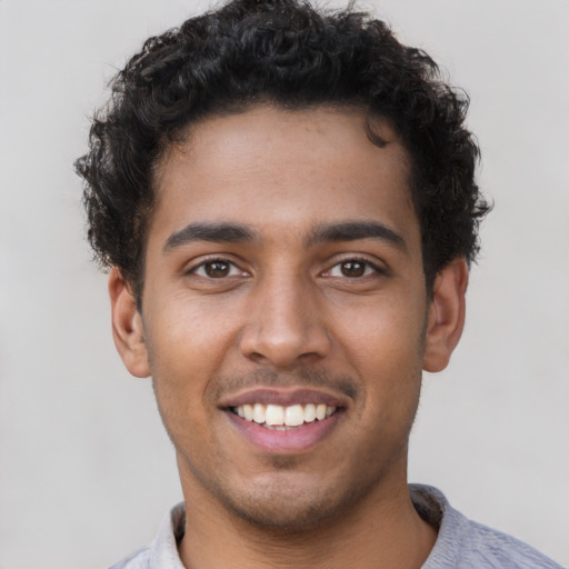 Joyful latino young-adult male with short  brown hair and brown eyes
